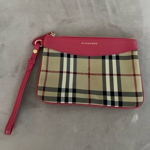 Unused Burberry clutch with packaging.